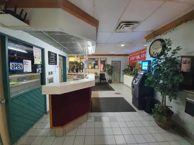 a fast food restaurant with a counter in a store at Sundre Motor Inn in Sundre