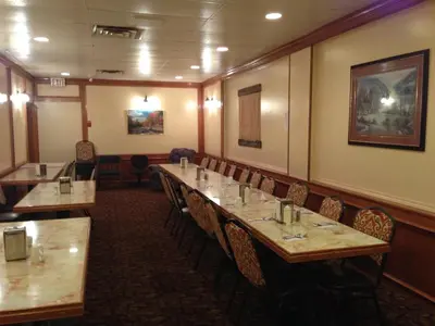 a dining room with wooden tables and chairs at Sundre Motor Inn in Sundre