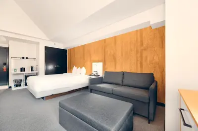 a hotel room with a bed and a couch at Aava Whistler Hotel in Whistler