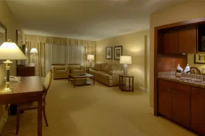a large hotel room with a living room at Prestige Vernon Lodge in Vernon