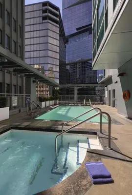 a swimming pool on the roof of a building at Coast Coal Harbour Vancouver Hotel by APA in Vancouver