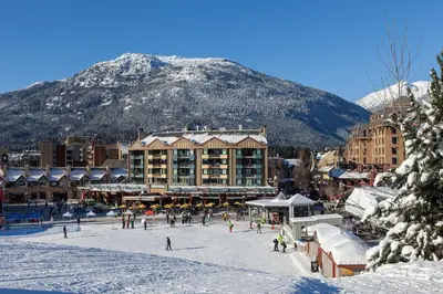 a ski resort with a mountain in the background at Gibbons Life Accommodations in Whistler