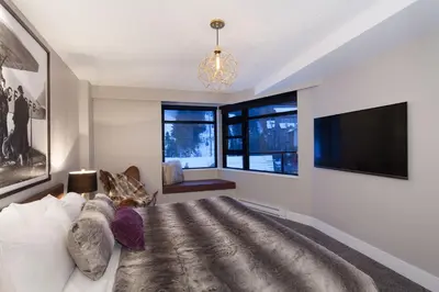 a living room with a couch and a flat screen tv at Gibbons Life Accommodations in Whistler