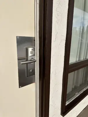 a door with a lock on a window at Howard Johnson by Wyndham Edson in Edson