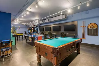 a pool table in a room with two tables at Hilton Grand Vacations Club Whistler in Whistler