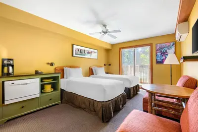 a hotel room with two beds and a table at Hilton Grand Vacations Club Whistler in Whistler