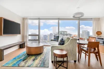 a living room with a table and a large window at Embarc Vancouver in Vancouver