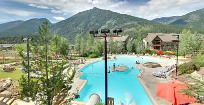 a resort with a large swimming pool with mountains in the background at Embarc Panorama in Panorama