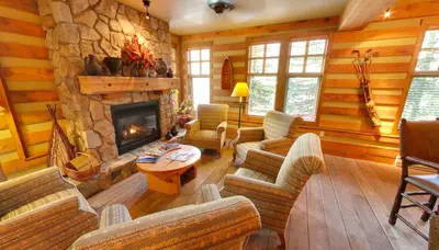a living room filled with furniture and a stone fireplace at Embarc Panorama in Panorama