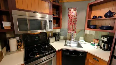 a kitchen with a microwave and a stove and a sink at Embarc Panorama in Panorama