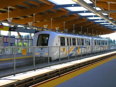 a subway train is stopped at a train station at Vancouver Homestay Inn in Richmond