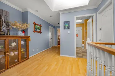 a hallway of a home with blue walls and wooden floors at Charming Family Hotel in Richmond