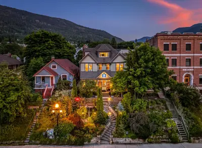 a house with a garden in front of a building at Cloudside Hotel in Nelson