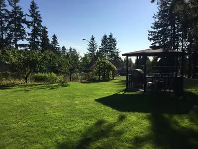 a yard with a gazebo in the grass at Vancouver Jenny's Guesthouse in Coquitlam
