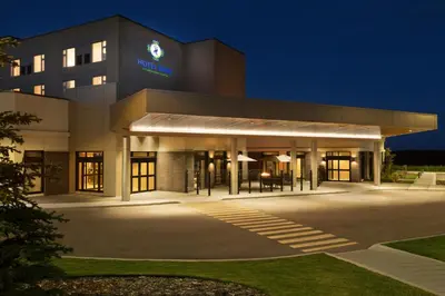 a hospital building at night with the lights on at Hotel Dene & Conference Centre in Cold Lake