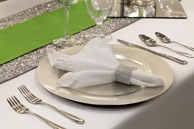 a white plate with a napkin and fork and knife at Hotel Dene & Conference Centre in Cold Lake