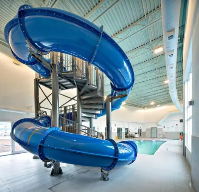 a blue water slide in a swimming pool at Holiday Inn Express - Red Deer North by IHG in Red Deer