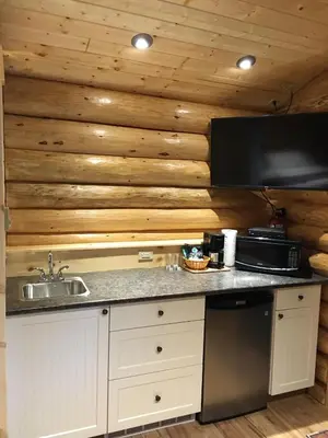 a kitchen with a sink and a counter top at Port Hardy Cabins in Port Hardy