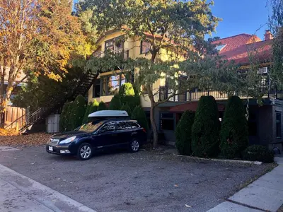 a black car parked in front of a house at Mistiso's Place in Nelson