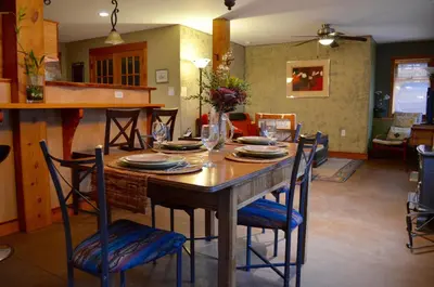 a wooden table with chairs and a dining room at Mistiso's Place in Nelson