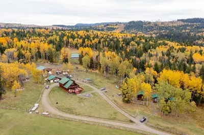an aerial view of a house in the middle of a forest at Montana Hill Guest Ranch in Bridge Lake