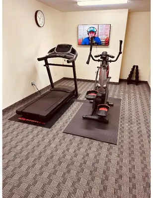 a room with a exercise bike and a treadmill at Aurora Park Inn & Suites in Dawson Creek