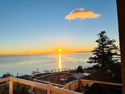 a view of the sun rising over the ocean at Donna's Bed & Breakfast in White Rock