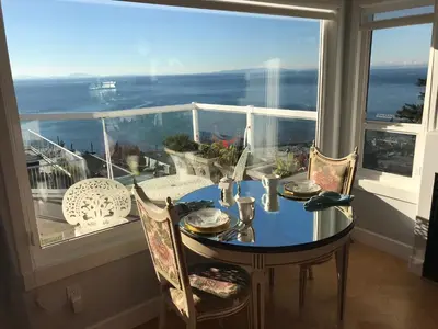 a dining room table with a view of the ocean at Donna's Bed & Breakfast in White Rock
