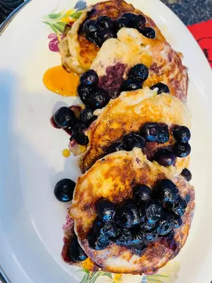 a plate of food with blueberries on it at Donna's Bed & Breakfast in White Rock