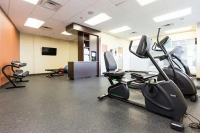 a gym with treadmills and elliptical machines at TownePlace Suites by Marriott Edmonton South in Edmonton