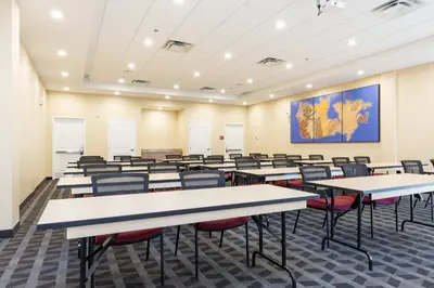 an empty classroom with tables and chairs at TownePlace Suites by Marriott Edmonton South in Edmonton