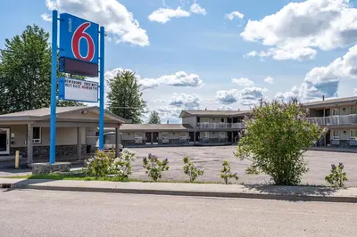 a no parking sign in front of a building at Motel 6-Fort Nelson, BC in Fort Nelson