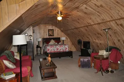 a room with a bed in a wooden ceiling at Garden House in Courtenay
