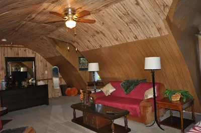 a living room with a ceiling fan and a couch at Garden House in Courtenay