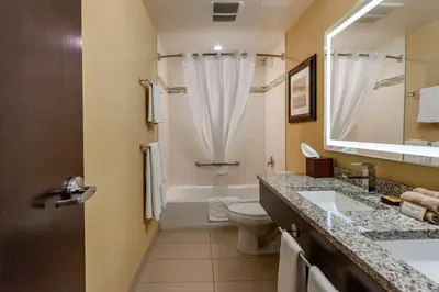 a bathroom with a tub and a toilet and a sink at Best Western Plus Drayton Valley in Drayton Valley