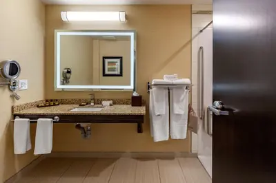 a bathroom with a sink and a mirror at Best Western Plus Drayton Valley in Drayton Valley