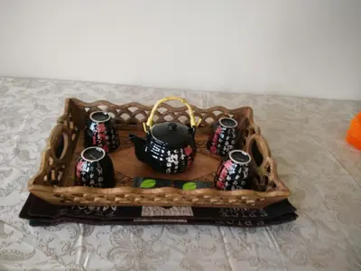 a tray with a tea kettle in a basket at Marpole Guest House in Vancouver