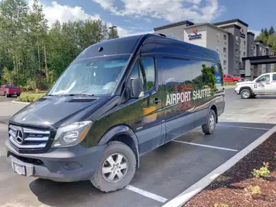 a large blue van parked in a parking lot at Comfort Inn & Suites in Terrace