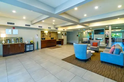 a large lobby with blue chairs and a waiting room at Comfort Inn & Suites in Terrace