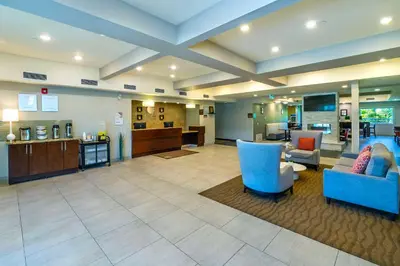 a large lobby with blue chairs and a waiting room at Comfort Inn & Suites in Terrace