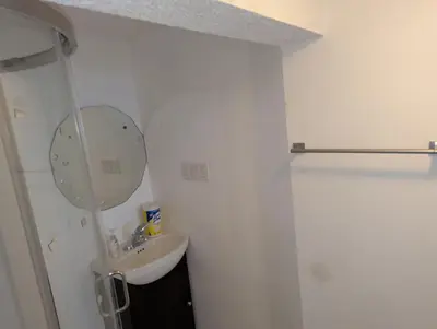 a white bathroom with a sink and a mirror at Calgary Star Cozy Home in Calgary