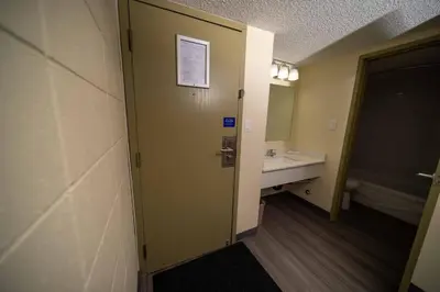 a bathroom with a sink and a mirror at Northern Lights Inn in Fort Saint John