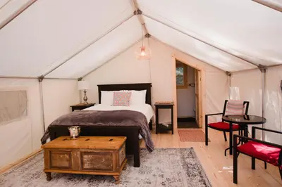 a bedroom with a bed in a tent at Cedar Haven Cabins and Resort in Clearwater