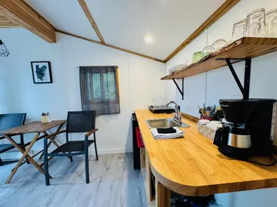 a kitchen with a wooden counter top and a table at Cedar Haven Cabins and Resort in Clearwater