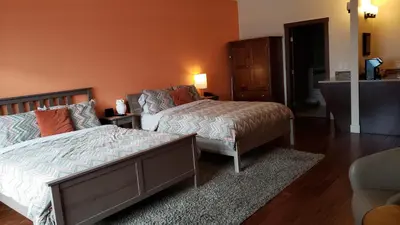 a bedroom with a bed and a dresser at Hillcrest Farm Market B&B in Kelowna