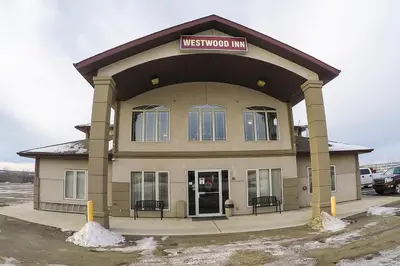 a building with a sign that reads westwood mall at Westwood Inn in Drayton Valley