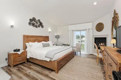 a bedroom with a large bed and a fireplace at Lakeshore Inn in Cold Lake