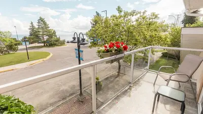 a balcony with chairs and a view of a street at Lakeshore Inn in Cold Lake