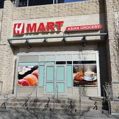 an asian grocery store with a sign on the front of it at Monki Di Executive Suites - Alura in Calgary