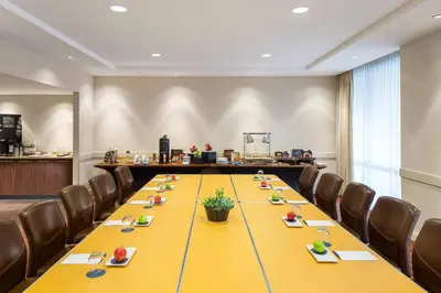 a conference room with a long yellow table and chairs at Sheraton Vancouver Airport Hotel in Richmond